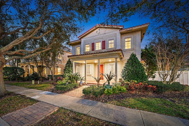 mediterranean / spanish home with covered porch