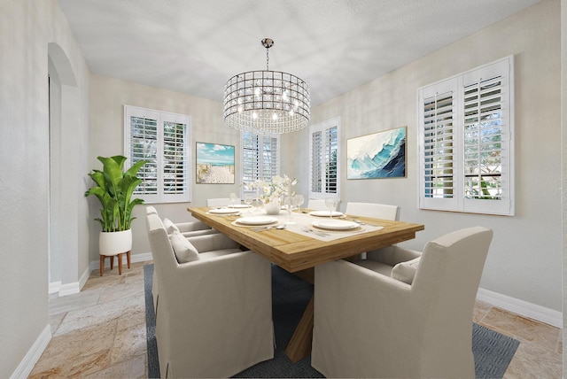 dining area with an inviting chandelier