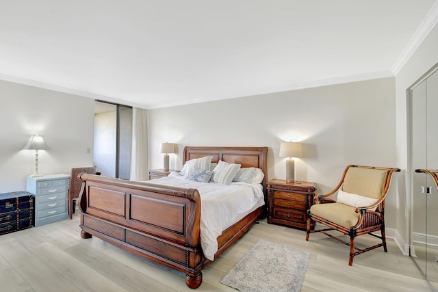 bedroom featuring crown molding, a closet, and light hardwood / wood-style flooring