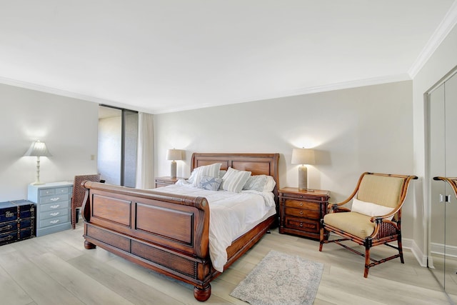 5080 N Ocean Dr Unit 20C, Riviera Beach, FL 33404 - bedroom with ornamental molding, light wood-style floors, baseboards, and a closet