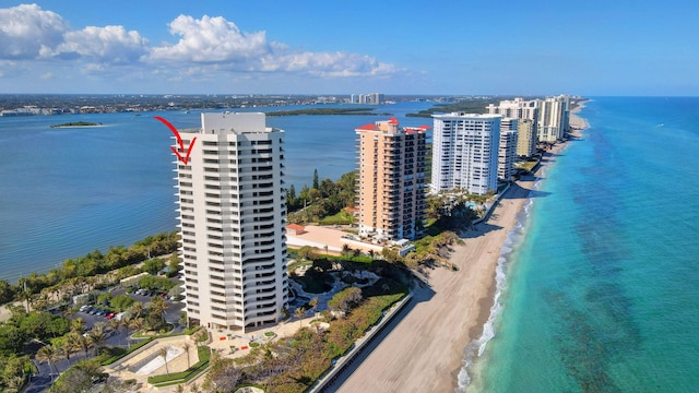 drone / aerial view with a water view and a beach view