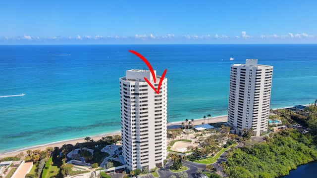 bird's eye view with a water view and a beach view