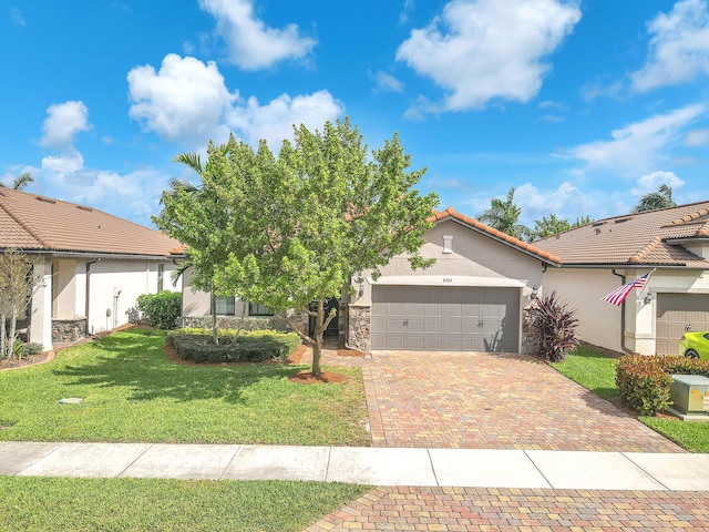 view of front of house featuring a garage and a front lawn