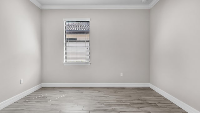 empty room featuring crown molding and light hardwood / wood-style flooring