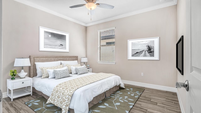 bedroom with hardwood / wood-style floors, crown molding, and ceiling fan