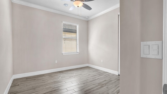 empty room featuring ornamental molding, ceiling fan, and light wood-type flooring