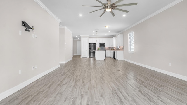 unfurnished living room with crown molding, ceiling fan, and light wood-type flooring