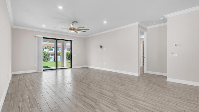 spare room featuring ornamental molding, ceiling fan, and light wood-type flooring