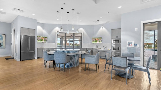 dining area featuring sink and light wood-type flooring