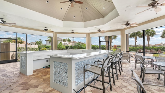 view of patio with a gazebo, ceiling fan, and exterior bar