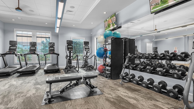 gym featuring a paneled ceiling and carpet flooring