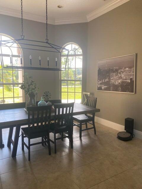 tiled dining area featuring crown molding