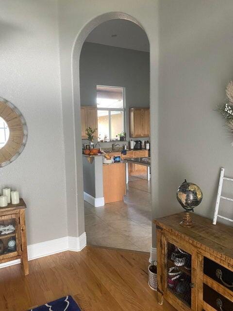 hallway with light hardwood / wood-style floors