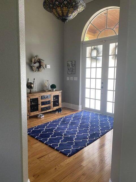 interior space featuring a notable chandelier, hardwood / wood-style flooring, and french doors