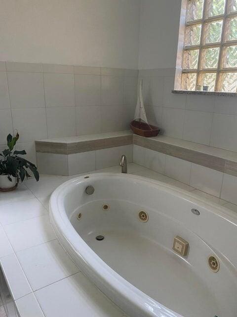 bathroom with tiled bath