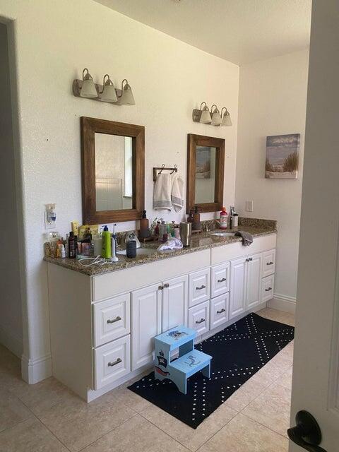 bathroom featuring tile patterned flooring and vanity