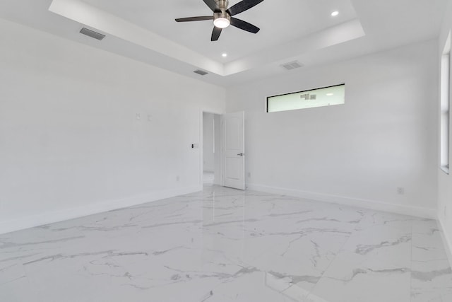 unfurnished room featuring visible vents, a tray ceiling, baseboards, and recessed lighting