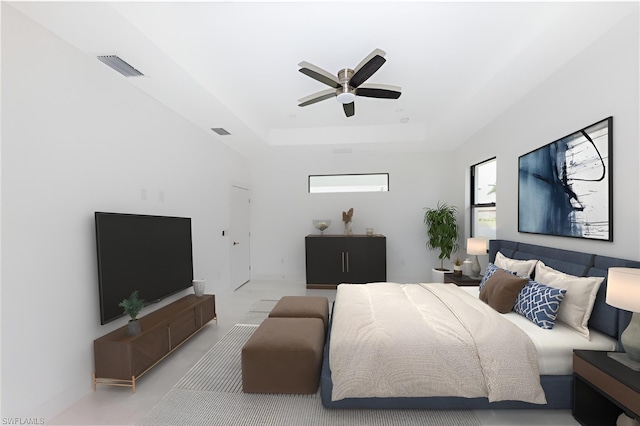 bedroom featuring ceiling fan, a tray ceiling, and visible vents