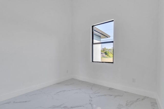 empty room with marble finish floor and baseboards