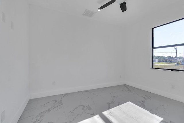 unfurnished room featuring marble finish floor, visible vents, ceiling fan, and baseboards