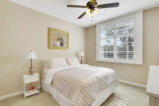 bedroom with ceiling fan and light colored carpet