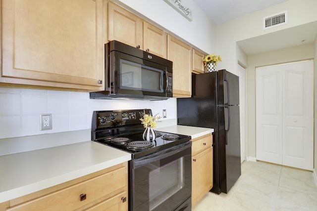 kitchen with light brown cabinetry, tasteful backsplash, and black appliances