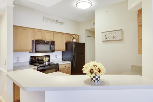 kitchen with kitchen peninsula, decorative backsplash, light brown cabinets, and black appliances