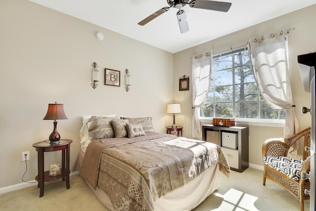 bedroom featuring light colored carpet and ceiling fan