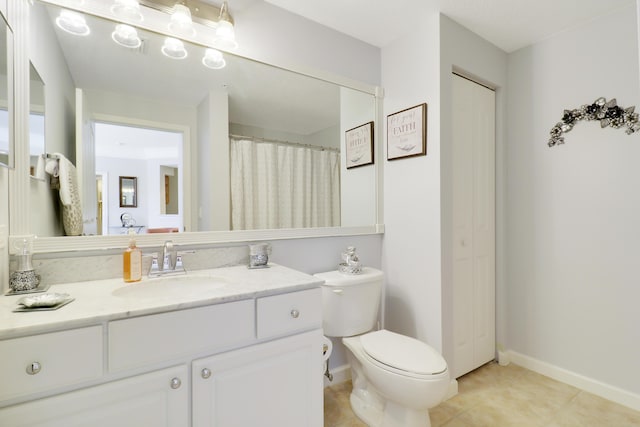 bathroom featuring vanity, tile patterned floors, and toilet