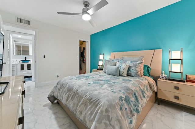 bedroom featuring a spacious closet, a closet, and ceiling fan