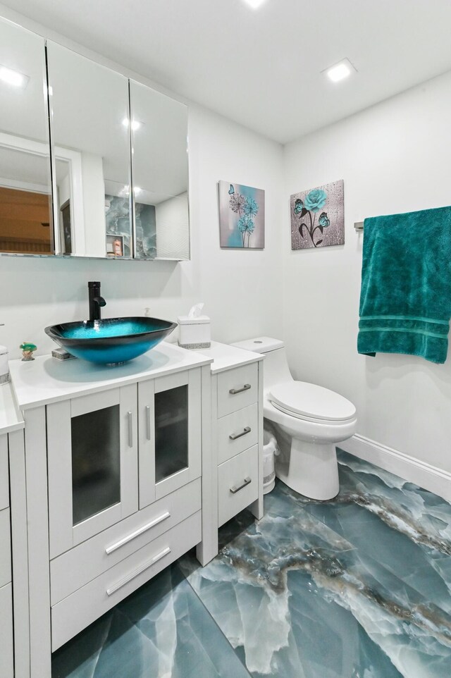 bathroom featuring vanity and toilet