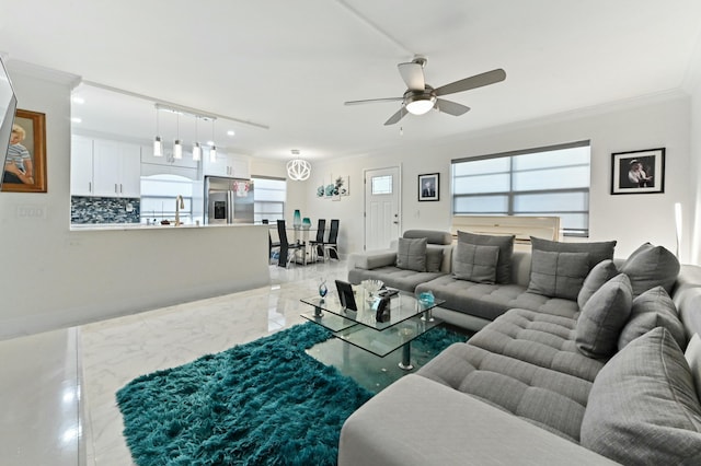 living room with sink, a wealth of natural light, ornamental molding, and ceiling fan