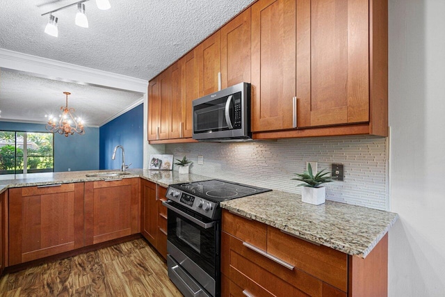 kitchen with dark hardwood / wood-style floors, sink, backsplash, ornamental molding, and stainless steel appliances