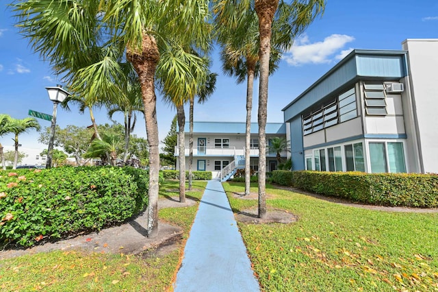 view of property's community with a lawn