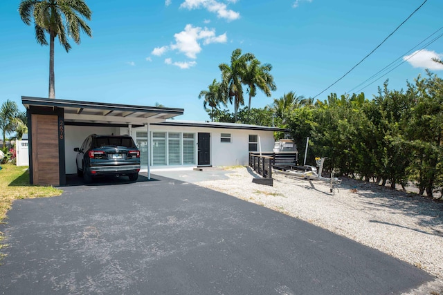 ranch-style home featuring a carport