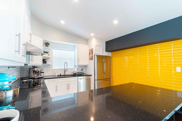 kitchen with tasteful backsplash, sink, white cabinets, exhaust hood, and stainless steel appliances