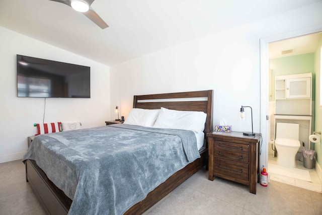 tiled bedroom featuring vaulted ceiling, ensuite bathroom, and ceiling fan