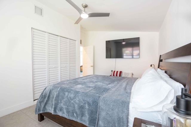 tiled bedroom featuring a closet and ceiling fan