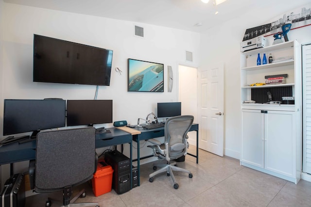 office space featuring vaulted ceiling and light tile patterned floors