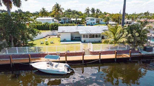 dock area featuring a yard and a water view