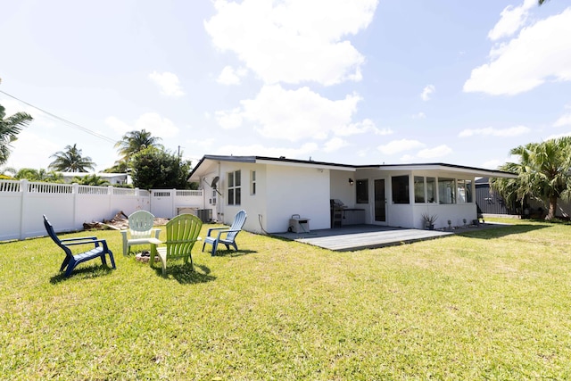 back of property featuring a yard and central air condition unit