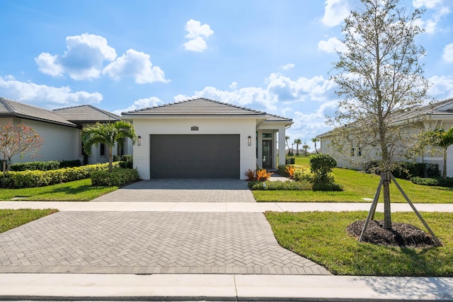 view of front of home with a front lawn and a garage