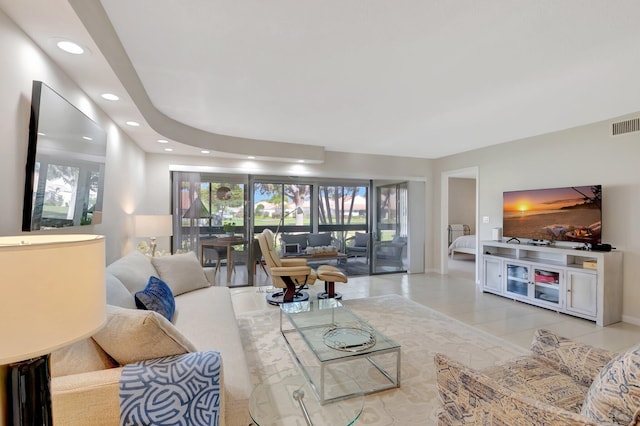 living room featuring light tile patterned flooring, visible vents, and recessed lighting