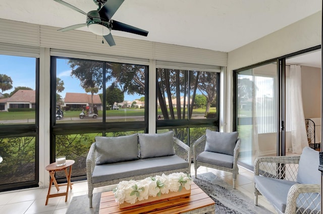 sunroom / solarium featuring ceiling fan