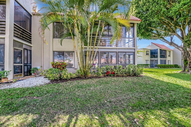 5659 Fairway Park Dr Unit 101, Boynton Beach, FL 33437 - back of property with stucco siding, a yard, and a tiled roof