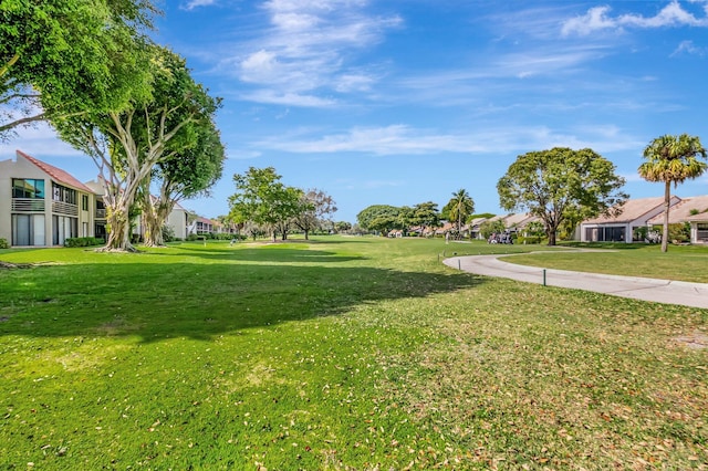 view of property's community with a lawn