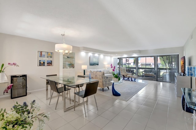 dining room featuring wine cooler, baseboards, and tile patterned floors