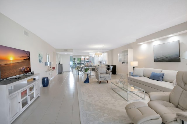 living room featuring light tile patterned flooring and a chandelier