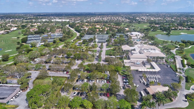 aerial view with a residential view, a water view, and golf course view