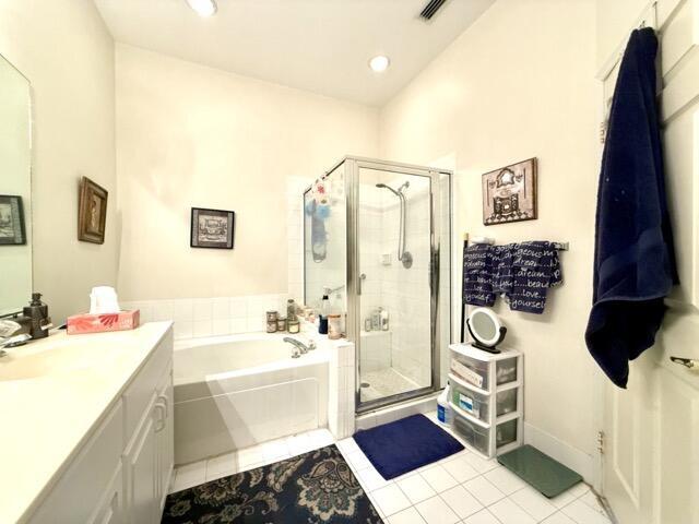 bathroom with vanity, tile patterned flooring, and independent shower and bath